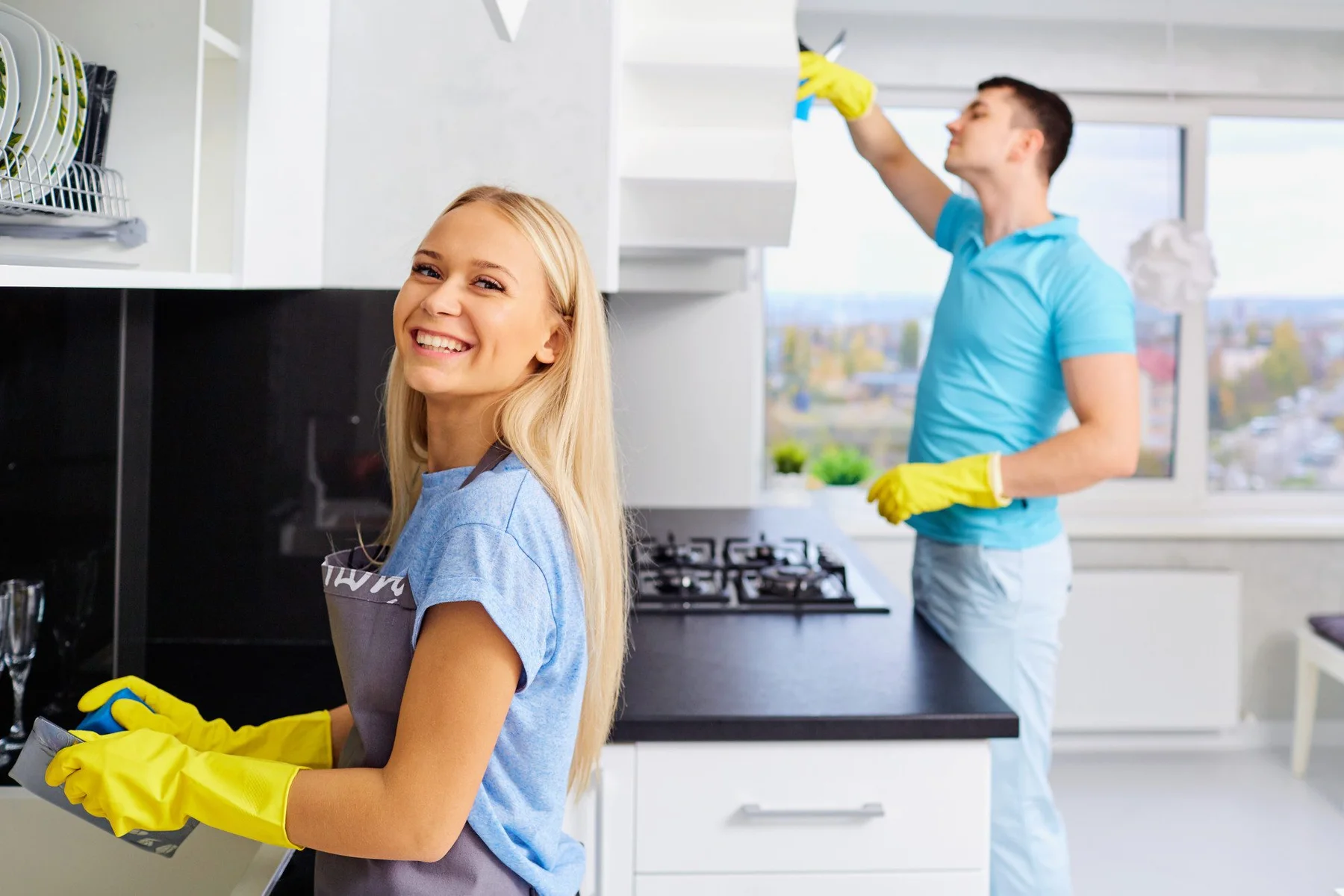 Young family couple cleaning in the house.