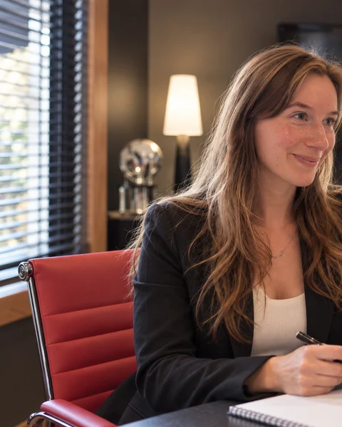 Kyra Gillette working at the meeting-room table