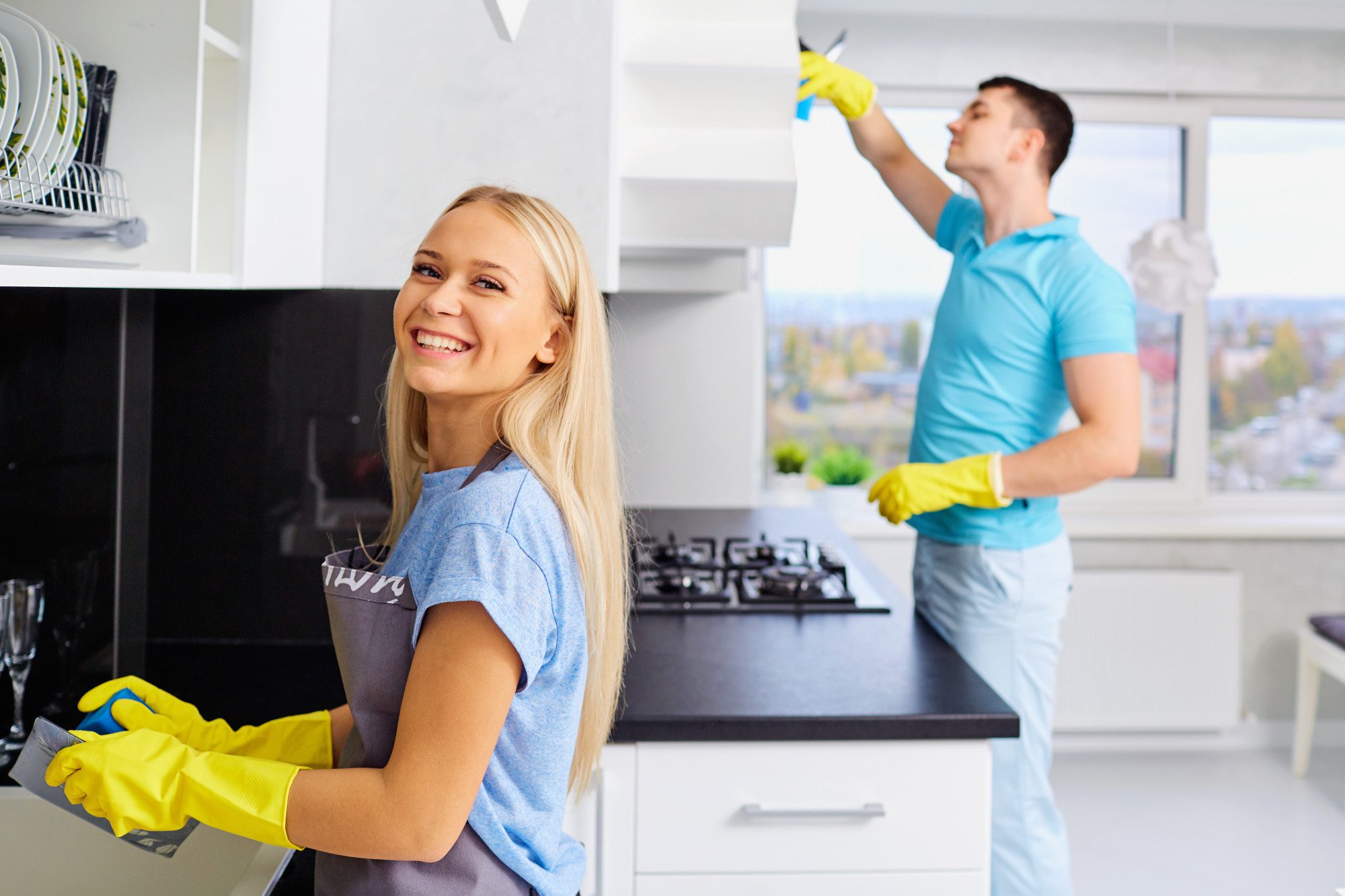 Young family couple cleaning in the house.