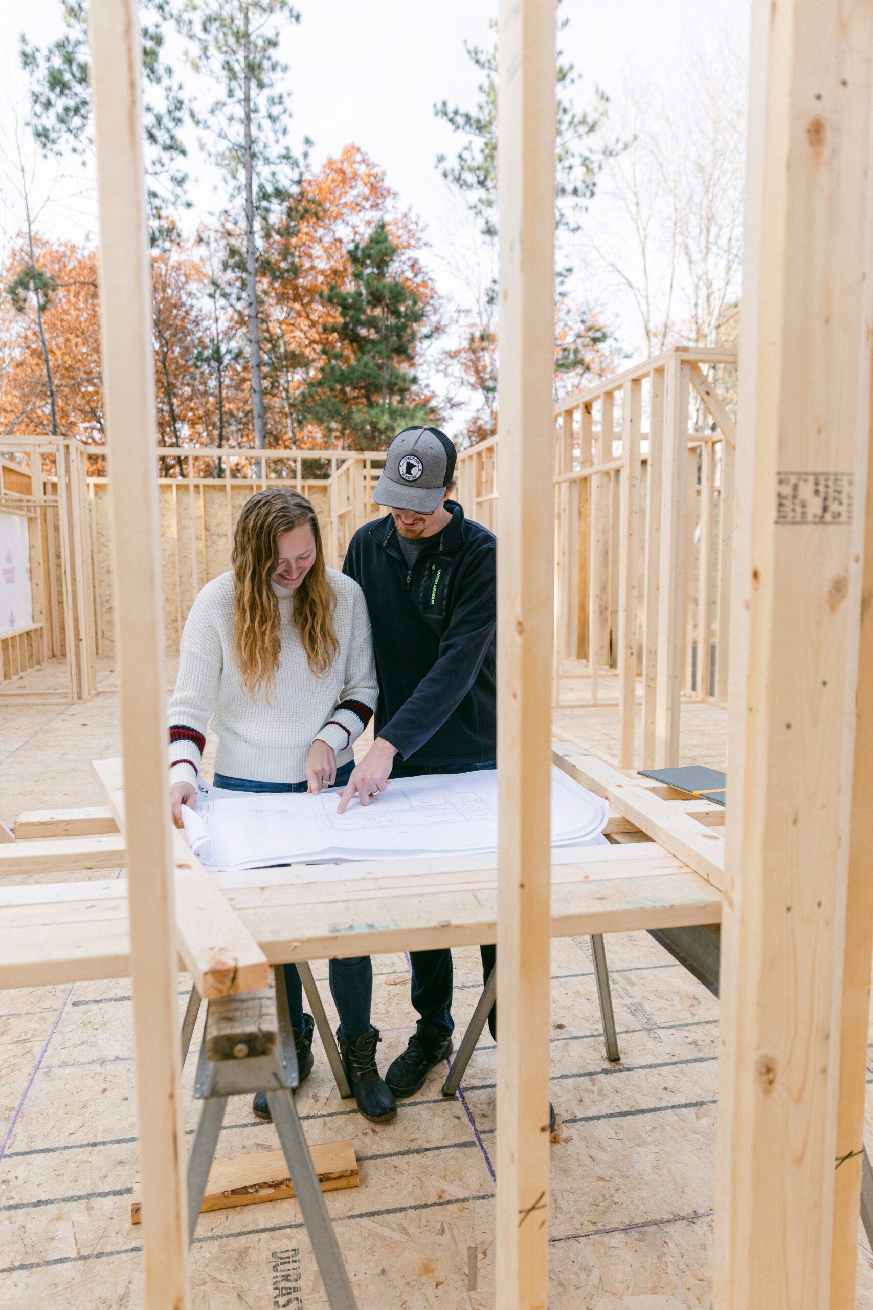 Couple Looking at Blue Prints for Newly Constructed Home